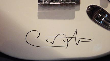 Detail of White Fender Stratocaster signed by Carlos Santana.